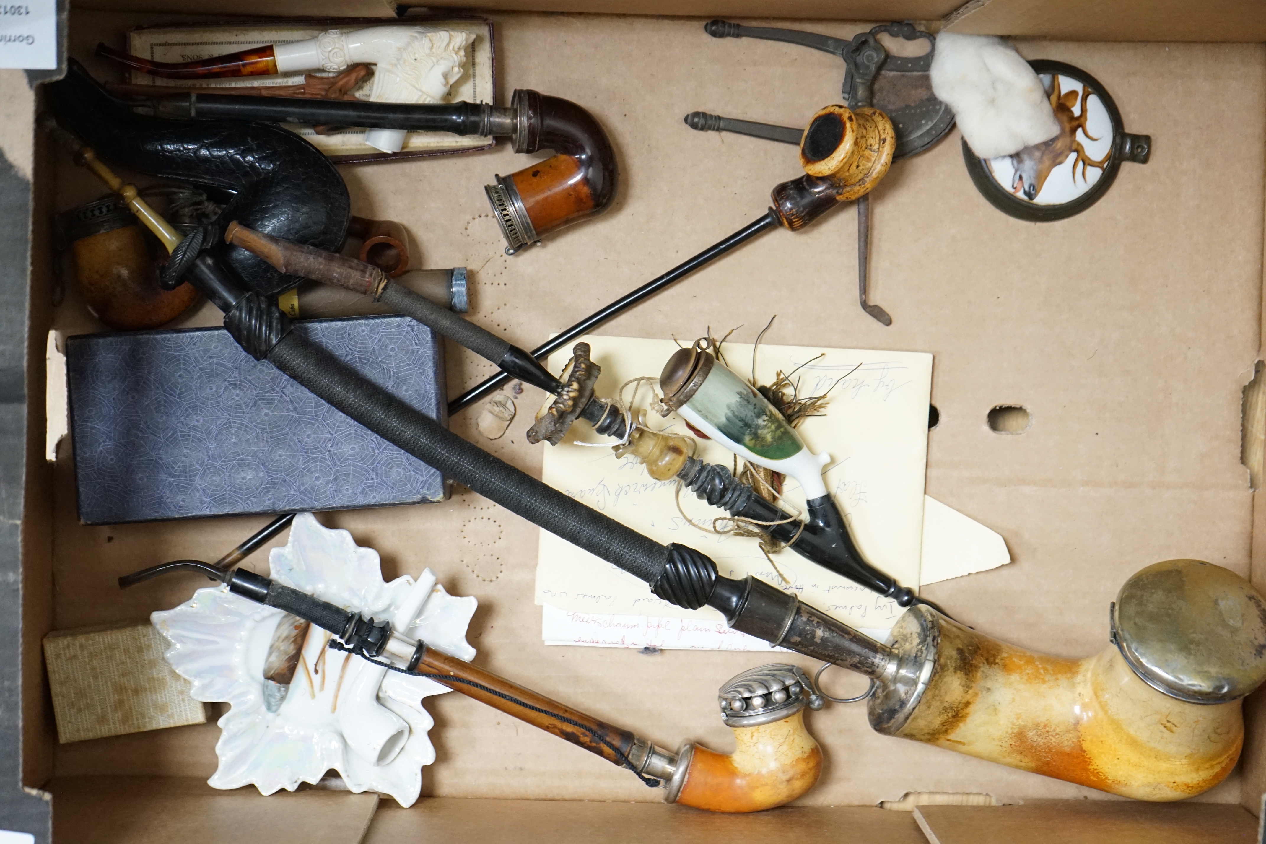 Ten mixed novelty pipes in various sizes with various mixed bowls, together with a small collection of mostly amber mouthpieces and other smoking related items, largest pipe 61cm long